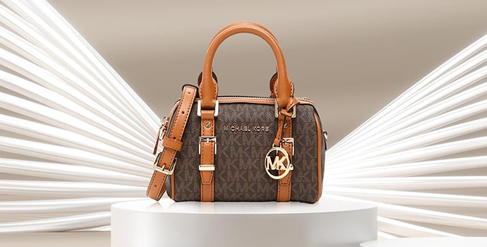 Michael Kors The Bedford Legacy Signature Bag on white table