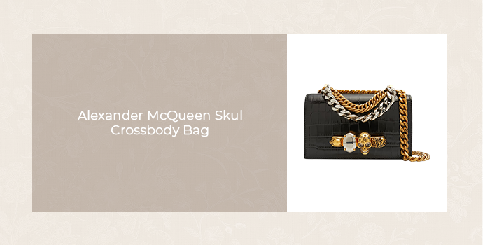 Alexander McQueen Skull crossbody bag in black with gold and silver chain detailing, featured in a luxury handbag product graphic.