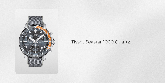 Tissot Seastar 1000 Quartz watch with dark dial, orange bezel accents, and stainless steel mesh strap